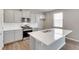 Modern kitchen with island, stainless steel appliances, and light gray cabinets at 14100 Black Sedge Cir, Parker, CO 80134