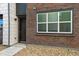 Townhome entry with brick facade and dark door at 455 Interlocken Blvd # 104, Broomfield, CO 80021