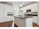 Modern kitchen with white cabinets, granite counters, and island at 455 Interlocken Blvd # 104, Broomfield, CO 80021