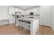 Modern kitchen featuring white cabinets, quartz countertops, and a large island at 14840 Hudson St, Thornton, CO 80602