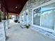 Covered porch entry with a light fixture and potted plants at 815 S Field St, Lakewood, CO 80226