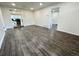 Open living room with wood-look floors and views into kitchen at 815 S Field St, Lakewood, CO 80226