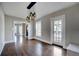 Charming dining room with hardwood floors, large windows, and view to living room at 3028 Meade St, Denver, CO 80211