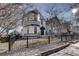 Two-story home with black fence and stone pathway at 3028 Meade St, Denver, CO 80211