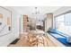 Modern dining area with built-in window seating and a round wooden table at 1452 S Vine St, Denver, CO 80210