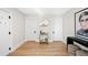 Light and airy entryway with hardwood floors and a modern bar cart at 1452 S Vine St, Denver, CO 80210