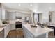 Bright kitchen featuring gray cabinets, stainless steel appliances, and an island at 849 Crest St, Lochbuie, CO 80603