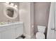 Bathroom with white vanity, gray tile, and a decorative mirror at 3574 Corsica Way, Castle Rock, CO 80109