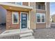 Stylish front entrance with a blue door and stone accents at 3574 Corsica Way, Castle Rock, CO 80109