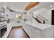 Modern kitchen with white cabinets, quartz countertops, and a large island at 3574 Corsica Way, Castle Rock, CO 80109