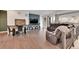 Living area with hardwood floors, a sectional sofa, and a fireplace at 3574 Corsica Way, Castle Rock, CO 80109