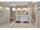 Double vanity bathroom with walk-in shower and patterned floor at 3574 Corsica Way, Castle Rock, CO 80109
