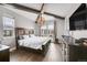 Spacious main bedroom with wood beams, chandelier, and large windows at 3574 Corsica Way, Castle Rock, CO 80109