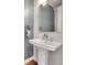 Modern powder room with pedestal sink and stylish wall accents at 3574 Corsica Way, Castle Rock, CO 80109