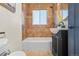 Updated bathroom with dark vanity and tile shower/tub combo at 1585 N Fairfax St, Denver, CO 80220