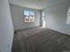 Bright bedroom with neutral carpeting and a large window offering natural light at 8807 Snake River St, Littleton, CO 80125