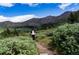 Person hiking on a mountain trail with scenic views at 2121 Hummingbird Way # 102, Georgetown, CO 80444