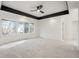 Bright bedroom with grey carpet, large windows, and a ceiling fan at 5577 E Links Cir, Centennial, CO 80122