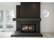 Contemporary fireplace with a dark wood accent wall at 5577 E Links Cir, Centennial, CO 80122