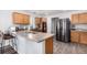 Kitchen with light wood cabinets, stainless steel appliances, and an island at 19415 Robins Dr, Denver, CO 80249