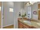 Elegant bathroom with granite countertop and wood cabinets at 5044 Starry Sky Way, Parker, CO 80134