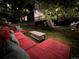 Night view of backyard with seating area and deck in background at 647 Briar Haven Dr, Castle Pines, CO 80108