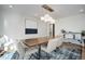 Bright dining area with a rustic table and statement lighting at 9650 Poundstone Pl, Greenwood Village, CO 80111