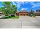 House exterior with a two-car garage and driveway at 6520 Virgil Way, Arvada, CO 80007