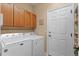 Laundry room with washer, dryer, and cabinets at 6520 Virgil Way, Arvada, CO 80007