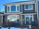 Backyard view of the house with deck, landscaping and some snow at 15063 E Crestridge Dr, Centennial, CO 80015