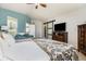 Large main bedroom with sitting area, barn door, and ensuite bathroom access at 15063 E Crestridge Dr, Centennial, CO 80015