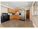 Kitchen with stainless steel appliances and wood cabinets at 4321 W Quinn Pl, Denver, CO 80236