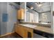 Kitchen with light wood cabinets, stainless steel appliances, and a breakfast bar at 910 Santa Fe Dr # 19, Denver, CO 80204