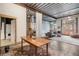 Open concept living area with exposed beams and large windows at 910 Santa Fe Dr # 19, Denver, CO 80204