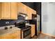 Modern kitchen with light wood cabinets and stainless steel appliances at 910 Santa Fe Dr # 19, Denver, CO 80204