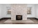 Stone fireplace with wood stove in a bright living room at 115 Johnson St, Frederick, CO 80530