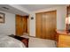 Basement bedroom with double door closet and adjacent bathroom at 9350 Grandview Ave, Arvada, CO 80002