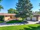 View of the home's backyard, showcasing a detached garage and landscaping at 9350 Grandview Ave, Arvada, CO 80002