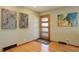 Bright entryway with hardwood floors, modern door, and artwork at 9350 Grandview Ave, Arvada, CO 80002