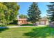 Ranch-style home with mature landscaping and large yard at 9350 Grandview Ave, Arvada, CO 80002