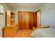 Well-lit bedroom featuring wood floors and double-door closet at 9350 Grandview Ave, Arvada, CO 80002