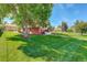 Brick house with a large green yard and driveway at 9350 Grandview Ave, Arvada, CO 80002