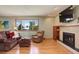 Living room with hardwood floors, fireplace, and large window at 9350 Grandview Ave, Arvada, CO 80002