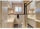 Retro bathroom with pink vanity and black and white tile floors at 9350 Grandview Ave, Arvada, CO 80002