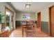 Charming dining room with hardwood floors and a view to the backyard at 9350 Grandview Ave, Arvada, CO 80002