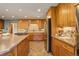 Modern kitchen with stainless steel appliances and custom cabinetry at 9350 Grandview Ave, Arvada, CO 80002