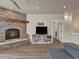 Gathering room with stone fireplace, built-in shelving, and a large window at 1516 Piney Hill Pt, Monument, CO 80132