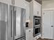 Modern kitchen with white cabinets and stainless steel appliances at 1516 Piney Hill Pt, Monument, CO 80132