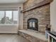 Stone fireplace with wood mantel and a black insert at 1516 Piney Hill Pt, Monument, CO 80132