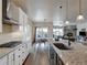 Modern kitchen with white cabinets, stainless steel appliances, and island at 1516 Piney Hill Pt, Monument, CO 80132